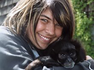 Young Ivy holding Maya the monkey at a wildlife event